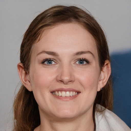 Joyful white young-adult female with medium  brown hair and blue eyes