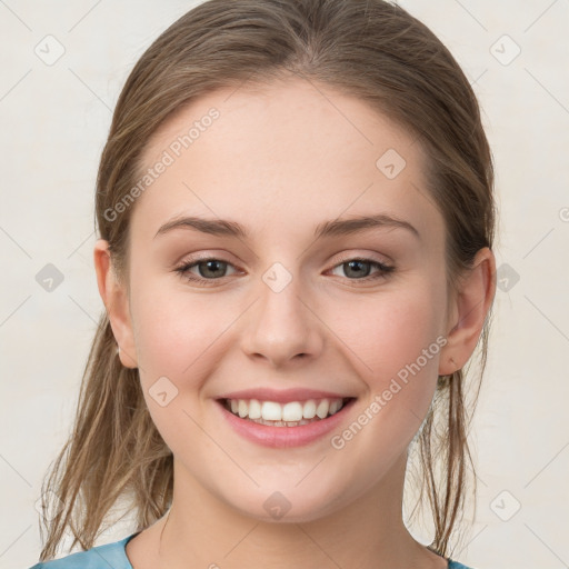 Joyful white young-adult female with medium  brown hair and grey eyes