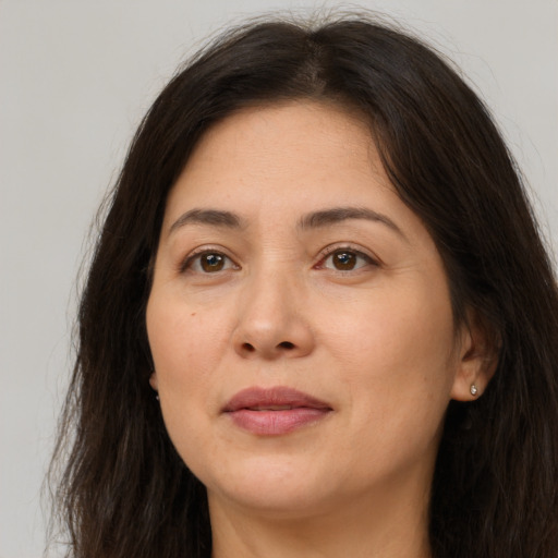 Joyful white adult female with long  brown hair and brown eyes