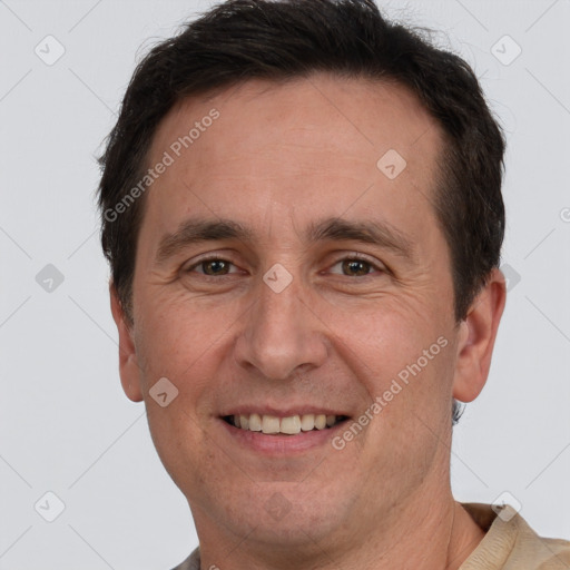 Joyful white adult male with short  brown hair and brown eyes