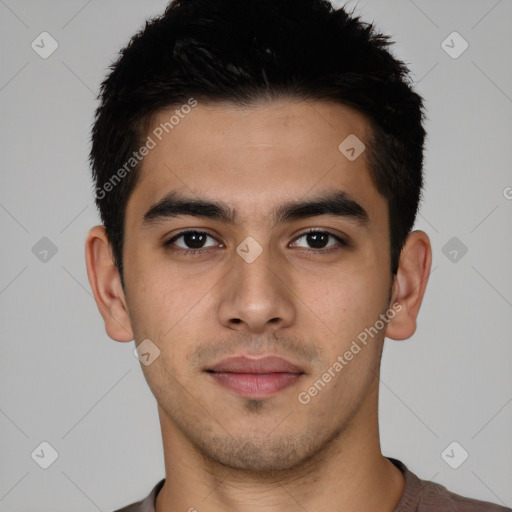 Joyful white young-adult male with short  black hair and brown eyes