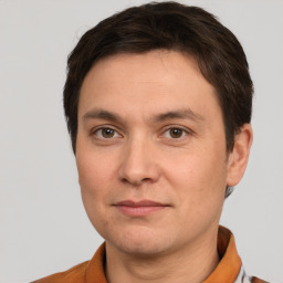 Joyful white young-adult male with short  brown hair and brown eyes