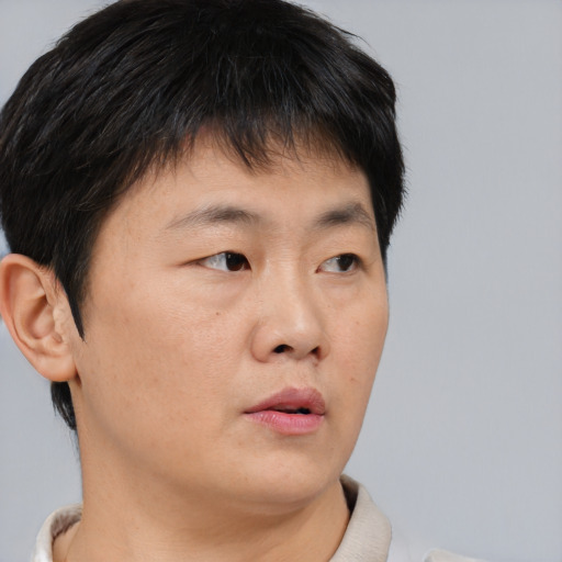 Neutral asian young-adult male with short  brown hair and brown eyes