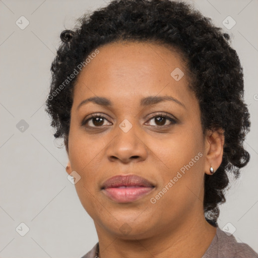 Joyful black adult female with short  brown hair and brown eyes