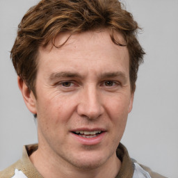 Joyful white adult male with short  brown hair and grey eyes