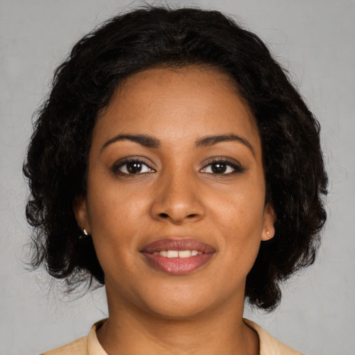 Joyful black young-adult female with medium  black hair and brown eyes