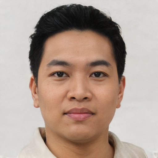 Joyful asian young-adult male with short  black hair and brown eyes