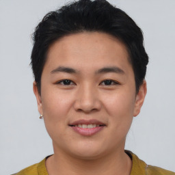 Joyful asian young-adult male with short  brown hair and brown eyes