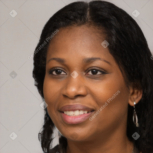 Joyful black young-adult female with long  black hair and brown eyes