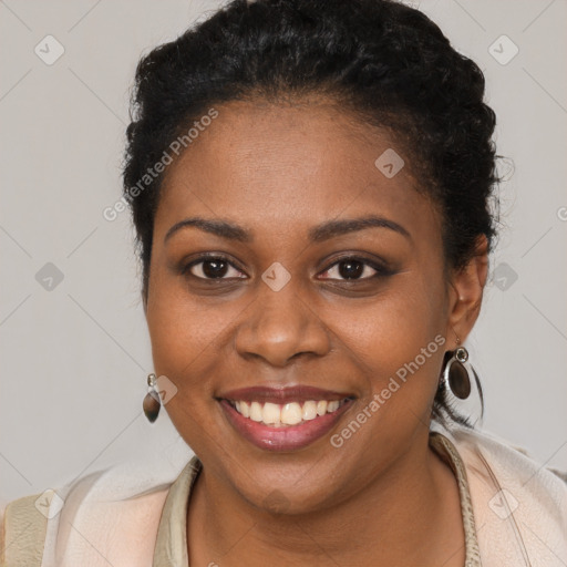 Joyful black young-adult female with long  brown hair and brown eyes