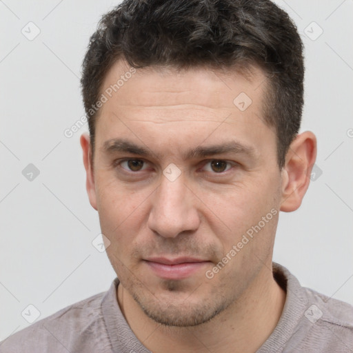 Joyful white adult male with short  brown hair and brown eyes