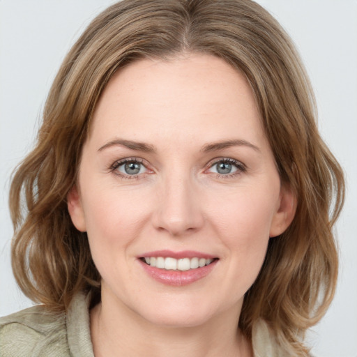 Joyful white young-adult female with medium  brown hair and green eyes