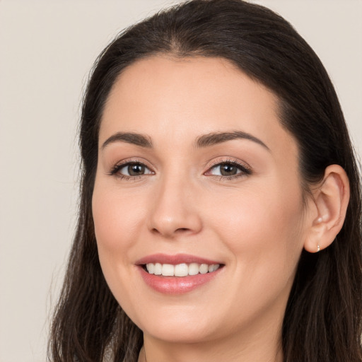 Joyful white young-adult female with long  brown hair and brown eyes