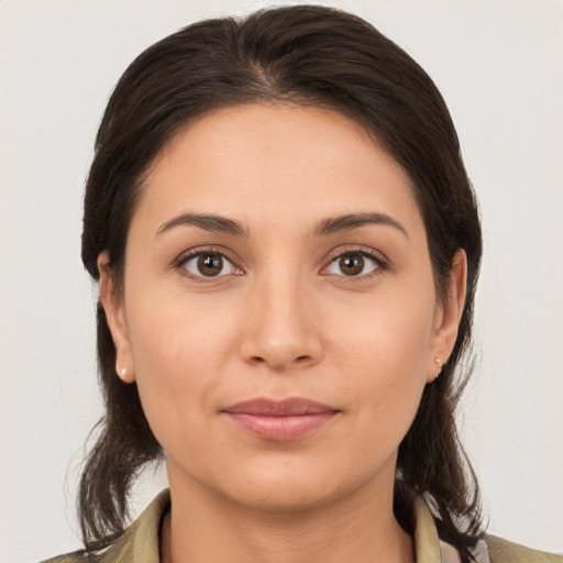 Joyful white young-adult female with medium  brown hair and brown eyes