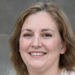 Joyful white adult female with medium  brown hair and grey eyes