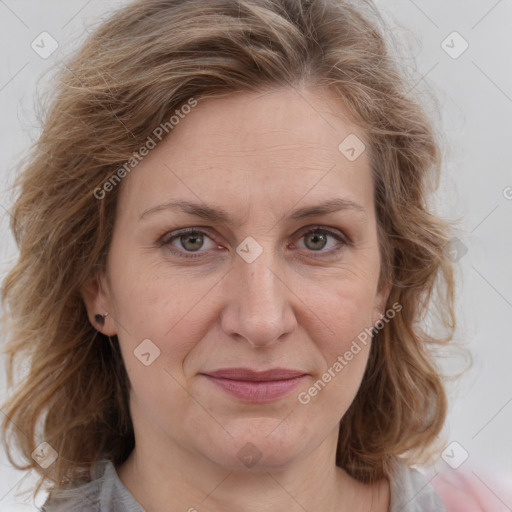 Joyful white adult female with medium  brown hair and blue eyes