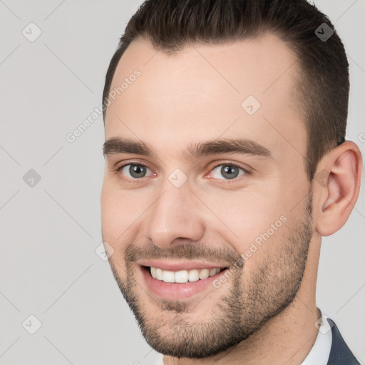 Joyful white young-adult male with short  brown hair and brown eyes