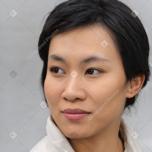 Joyful asian young-adult female with medium  black hair and brown eyes