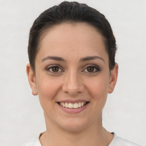 Joyful white young-adult female with short  brown hair and brown eyes