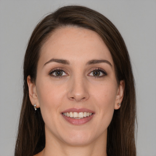 Joyful white young-adult female with long  brown hair and grey eyes