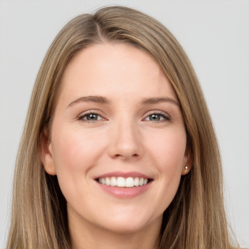 Joyful white young-adult female with long  brown hair and grey eyes