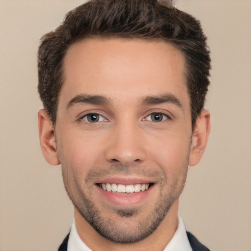 Joyful white young-adult male with short  brown hair and brown eyes