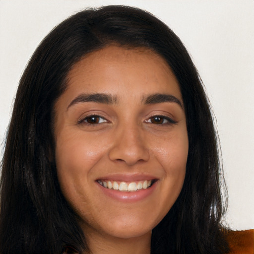 Joyful latino young-adult female with long  brown hair and brown eyes