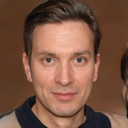 Joyful white adult male with short  brown hair and brown eyes