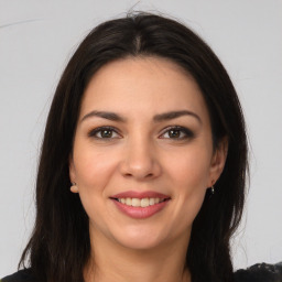 Joyful white young-adult female with long  brown hair and brown eyes