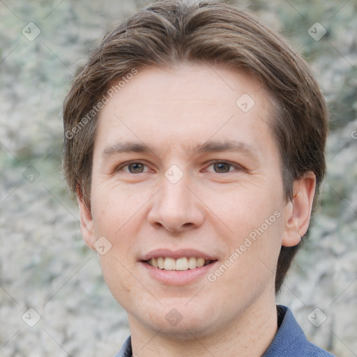 Joyful white adult male with short  brown hair and grey eyes