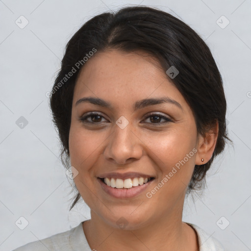 Joyful latino young-adult female with medium  brown hair and brown eyes