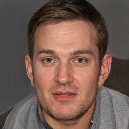 Joyful white adult male with short  brown hair and brown eyes