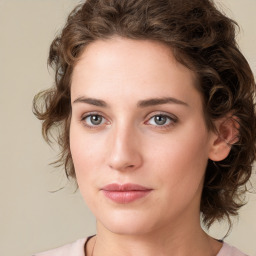 Joyful white young-adult female with medium  brown hair and green eyes