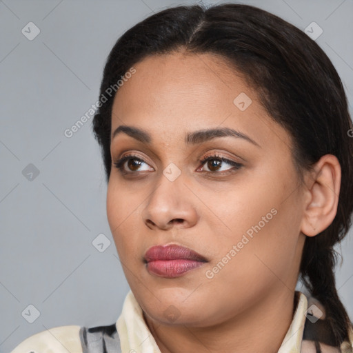 Joyful latino young-adult female with medium  brown hair and brown eyes