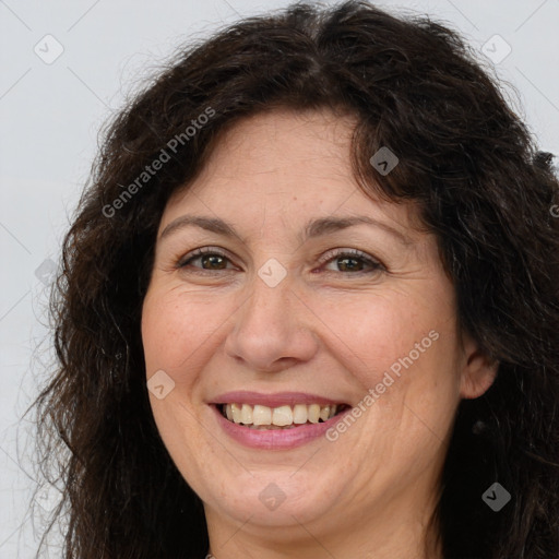 Joyful white adult female with long  brown hair and brown eyes