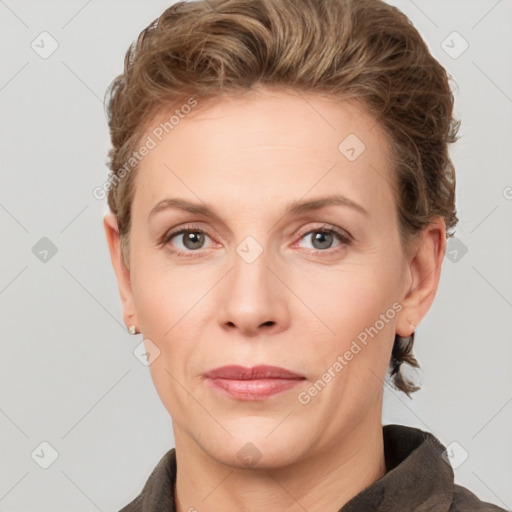 Joyful white adult female with short  brown hair and grey eyes