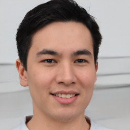 Joyful asian young-adult male with short  black hair and brown eyes