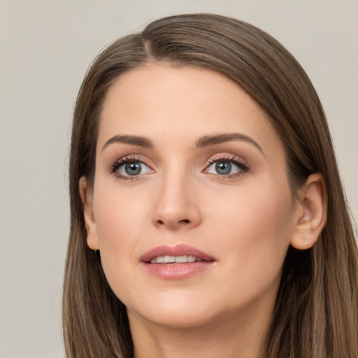 Joyful white young-adult female with long  brown hair and grey eyes