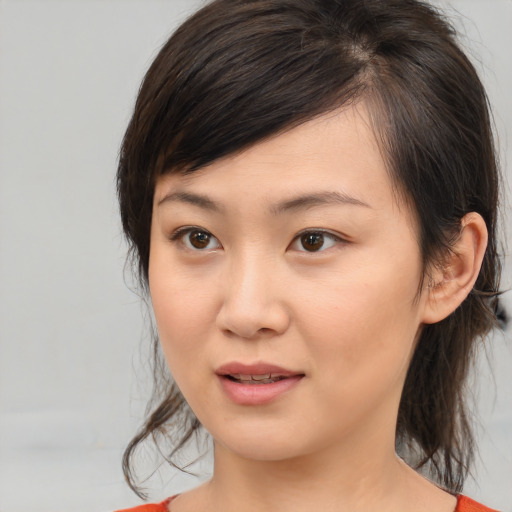 Joyful asian young-adult female with medium  brown hair and brown eyes
