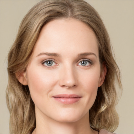 Joyful white young-adult female with medium  brown hair and green eyes