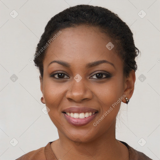 Joyful black young-adult female with short  brown hair and brown eyes