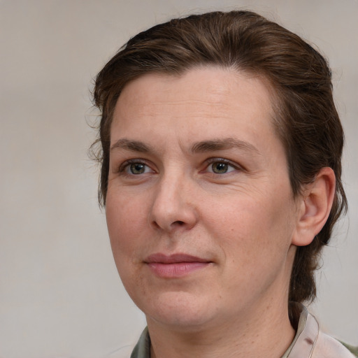 Joyful white adult female with medium  brown hair and grey eyes