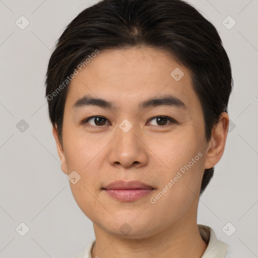 Joyful asian young-adult male with short  brown hair and brown eyes