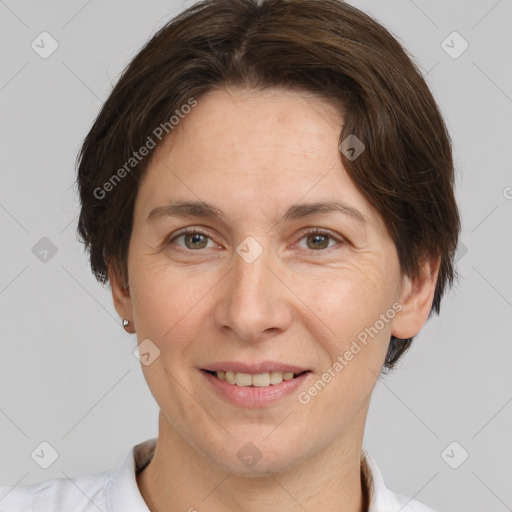 Joyful white adult female with short  brown hair and grey eyes