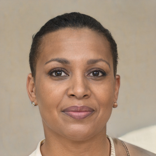 Joyful black adult female with short  brown hair and brown eyes