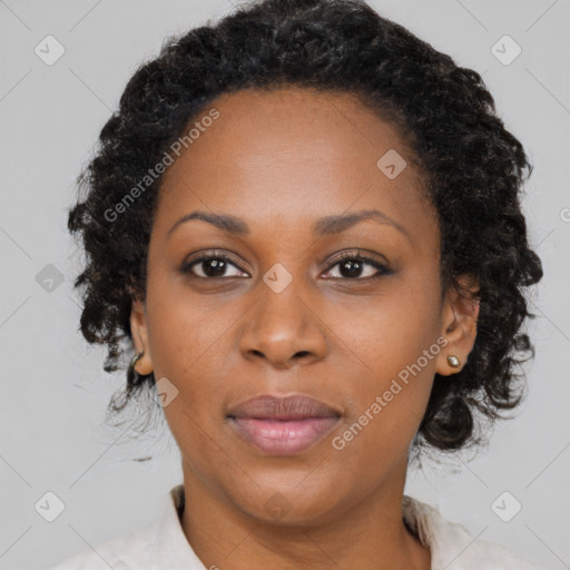 Joyful black adult female with medium  brown hair and brown eyes