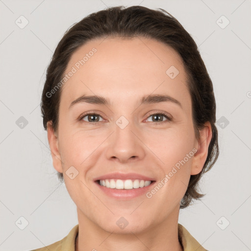 Joyful white young-adult female with medium  brown hair and grey eyes