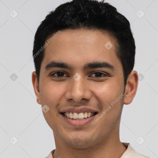 Joyful latino young-adult male with short  brown hair and brown eyes