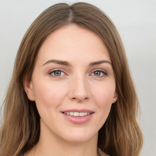 Joyful white young-adult female with long  brown hair and grey eyes