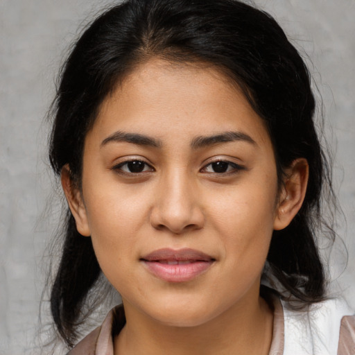 Joyful latino young-adult female with medium  brown hair and brown eyes